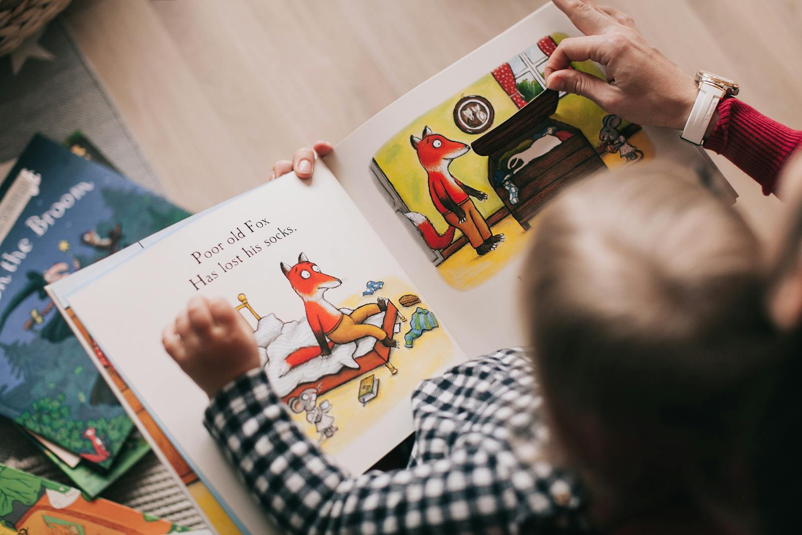 Child reading an illustrated picture book with colorful artwork.